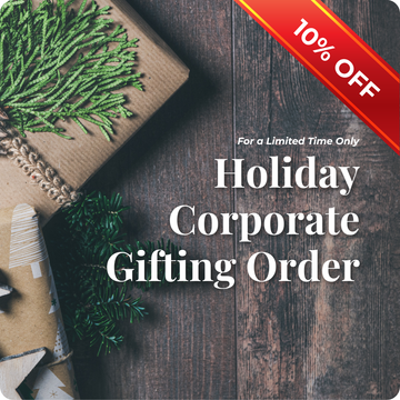 Promotional graphic for holiday corporate gifting with gift boxes and tinsel on a wooden surface, featuring a 10% discount offer.