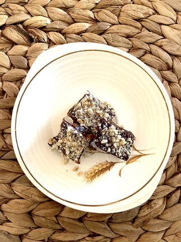 Squares of chocolate and almond covered toffee on a plate