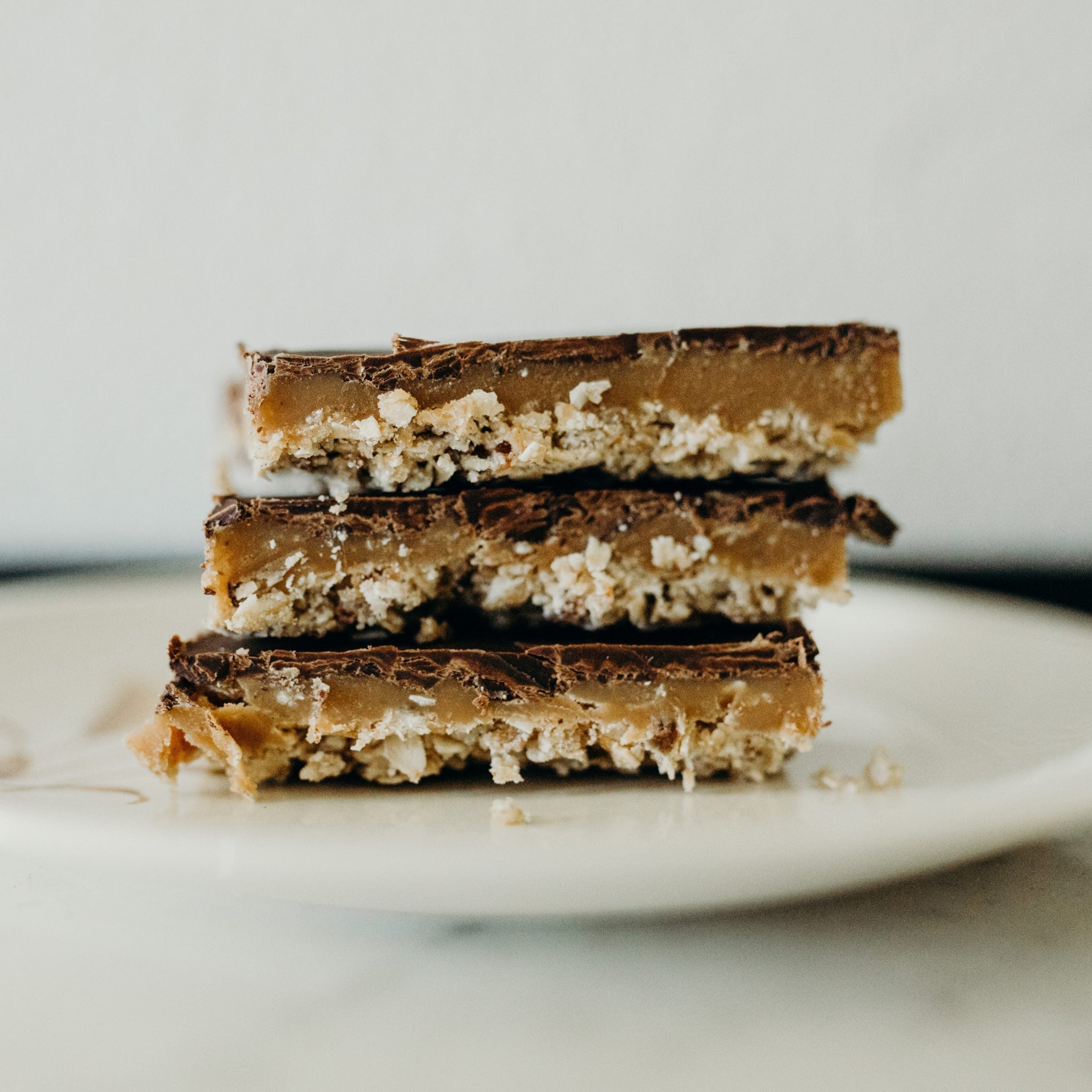 Caramel, chocolate and nut layers in thin bars