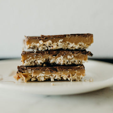 Caramel, chocolate and nut layers in thin bars