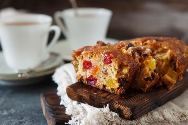fruitcake sliced with a cup of coffee