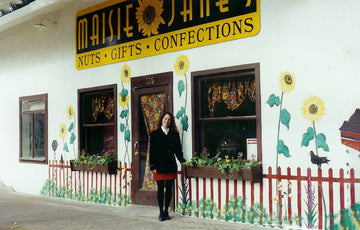 Maisie Jane standing in front of her first storefront for Maisie Janes