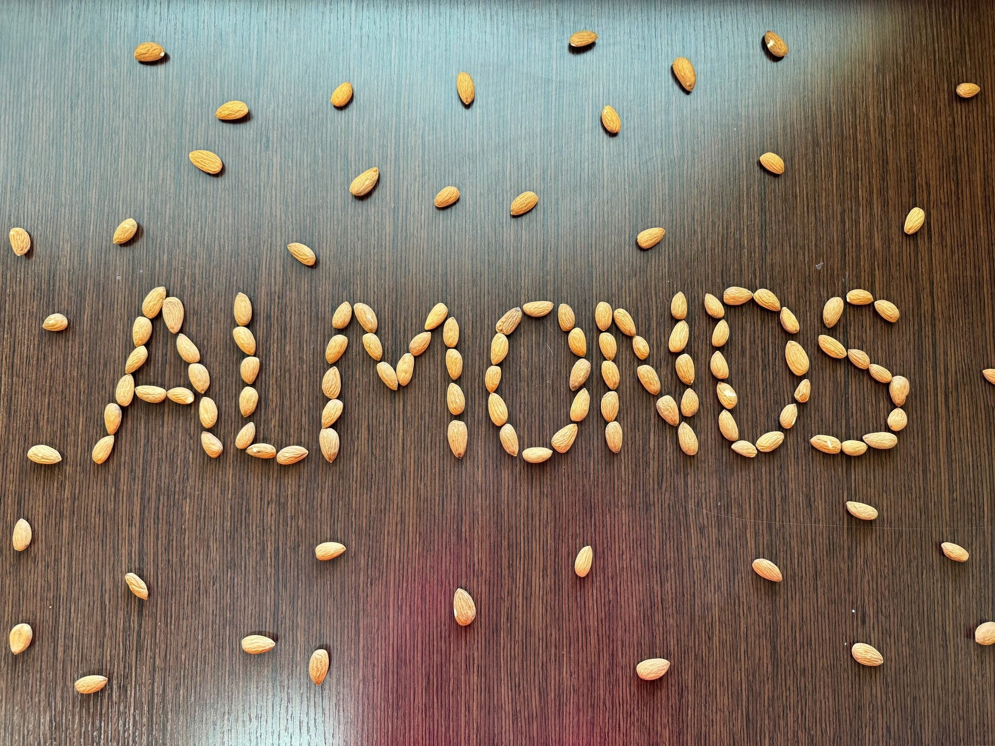 The word ALMONDS created with almonds