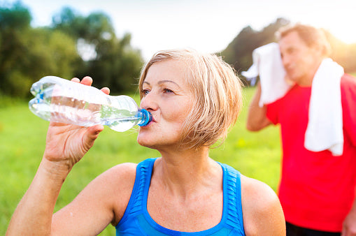 older couple drinking bottled water