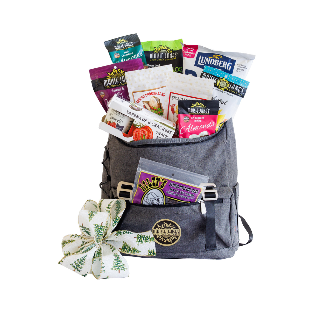Gray backpack filled with snacks and a decorative bow on a white background