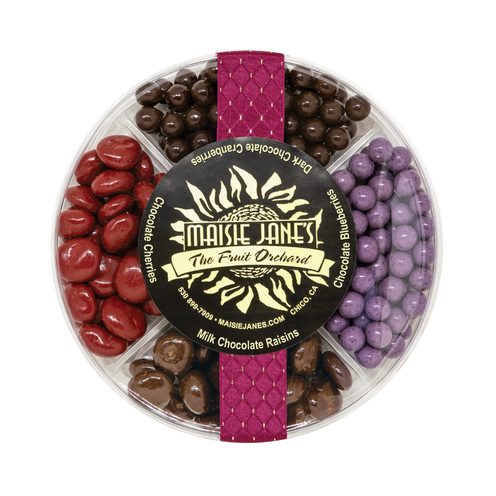 Assorted chocolate candies in a round display with 'Maisie Janes' label.