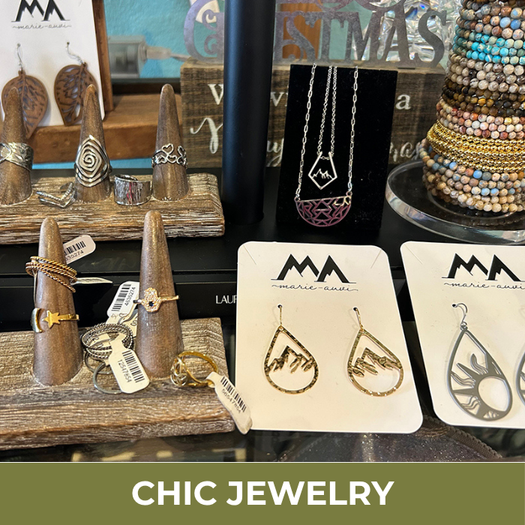Jewelry display with earrings on cards and various items in the background