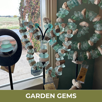 Decorative wreath made of stones and glass beads with 'Garden Gems' text.