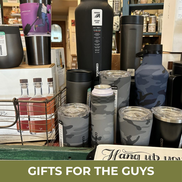 Collection of insulated tumblers and bottles on a store shelf with 'Gifts for the Guys' text.