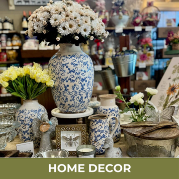 Display of home decor items including vases and flowers in a store setting.