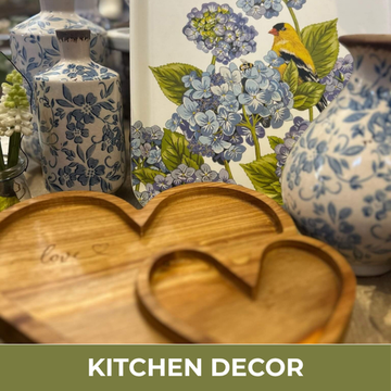 Kitchen decor with floral-patterned vases and a wooden heart-shaped object.